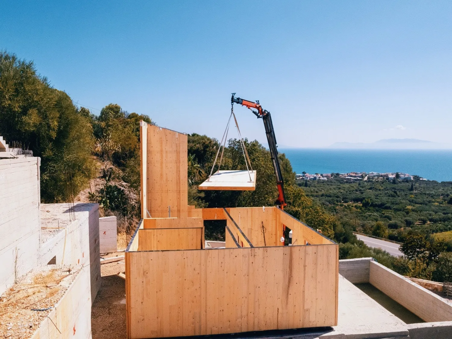 CLT panel installation by crane on an Ionian construction site